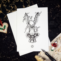 Yule Hare - 5x7 blank greeting card with black and white ink pen illustration of a long-eared hair in bust portrait. Around its neck is a wreath of holly with a bell and satin cravat-style ribbon. Holly winds around its upright ears, and beneath it shines a luminous 5-pointed star.